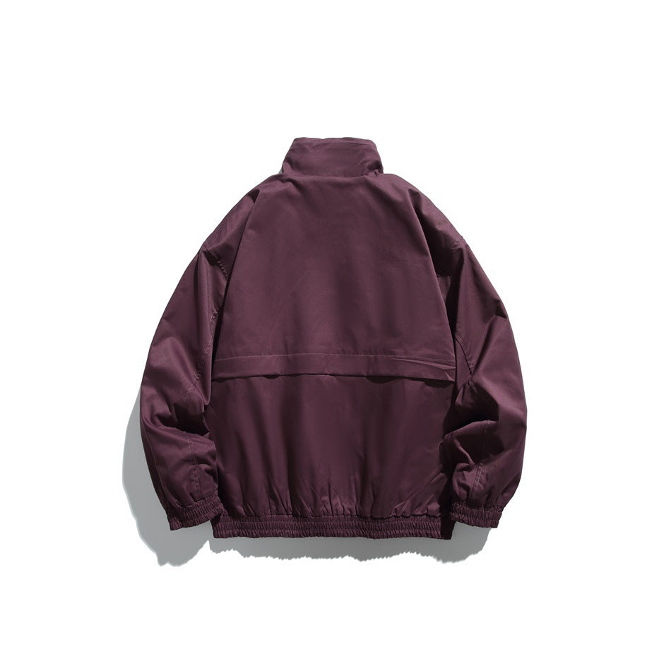 Back view of a plum jacket with a stand collar, a horizontal upper-back seam, and elastic cuffs and hem.