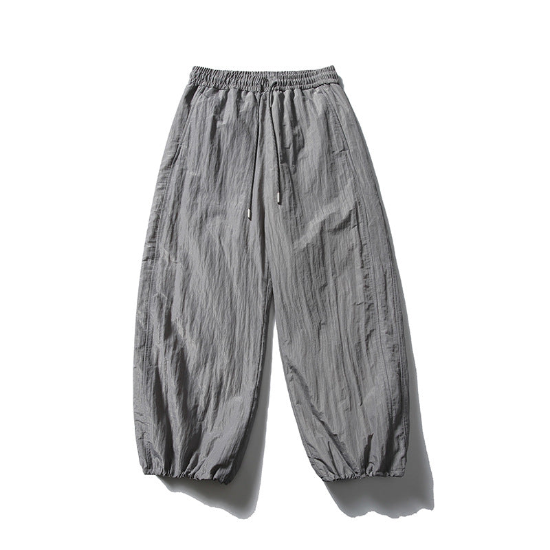 Gray wide-leg drawstring pants with crinkled texture and gathered hems, flat front view