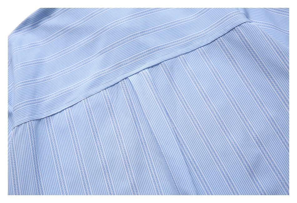 Close-up of the back yoke seam on a light blue and white striped shirt.