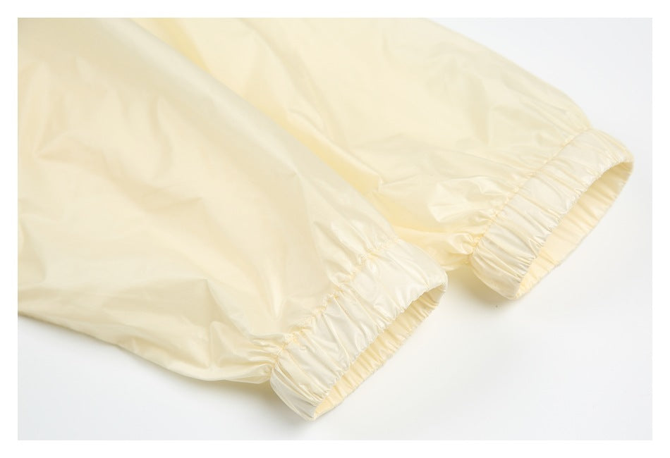 Close-up of pale yellow garment legs ending in gathered elastic cuffs.