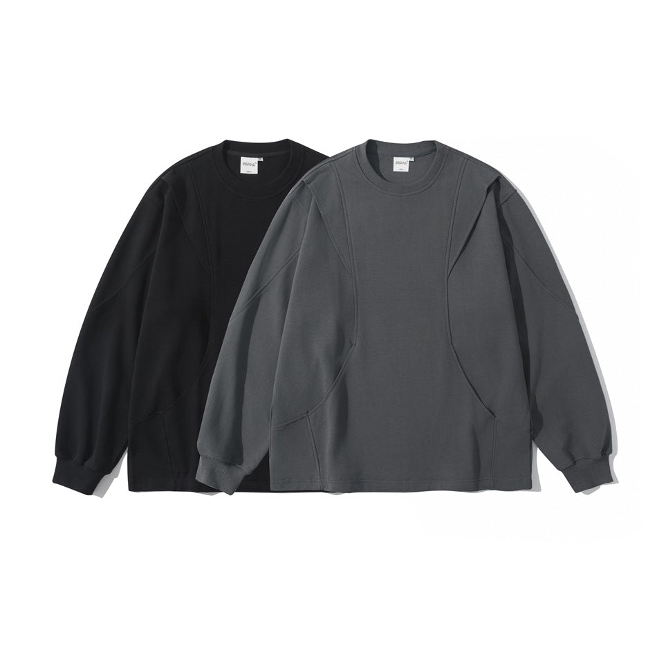 Two long-sleeve crewneck sweatshirts shown from the front in black and charcoal gray, with curved seam panels and ribbed