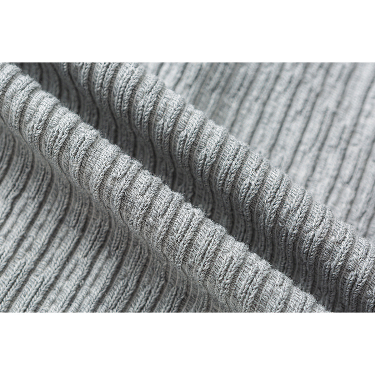 Close-up showing the textured ribbed knit of a light gray garment.