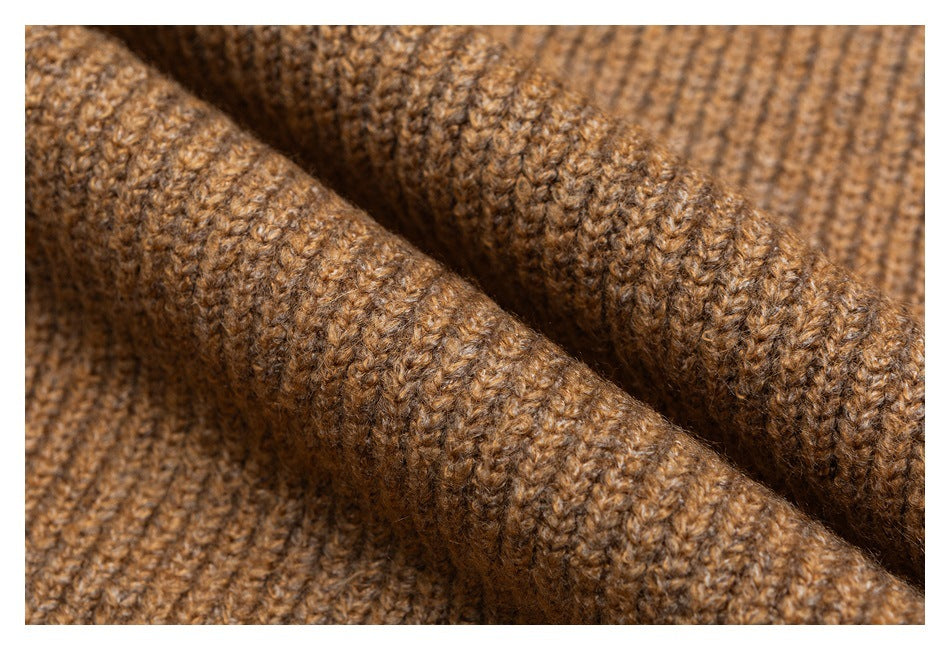 Extreme close-up showing the brown sweater's textured knit stitches.