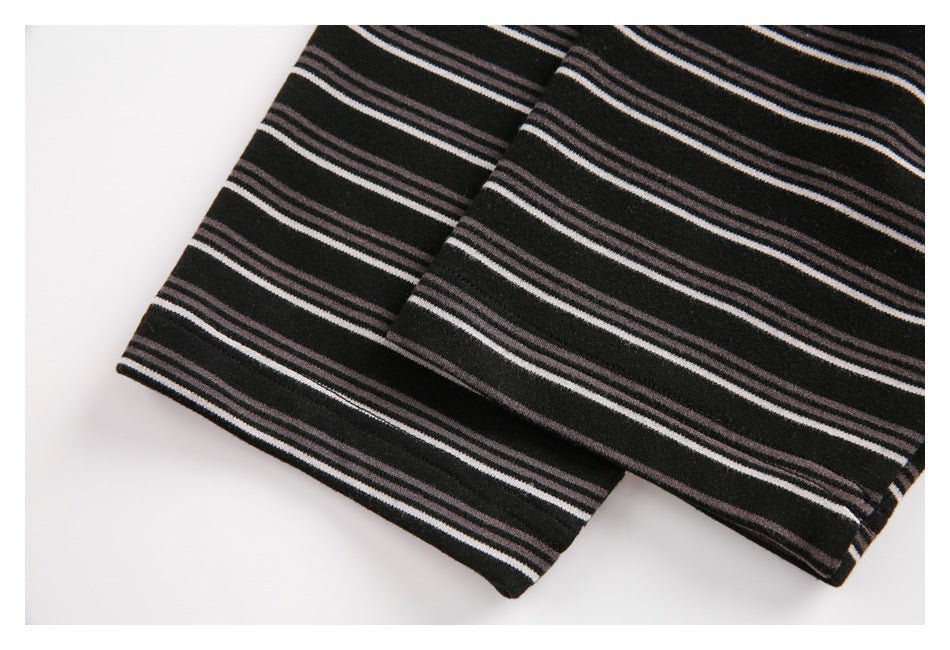 Close-up of the striped top's hem and overlapping fabric edges.