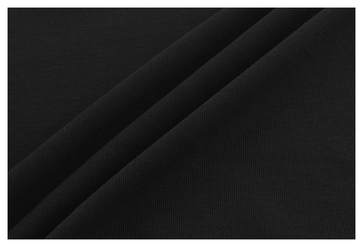 Close-up of black fabric draped in folds, showing its surface texture.