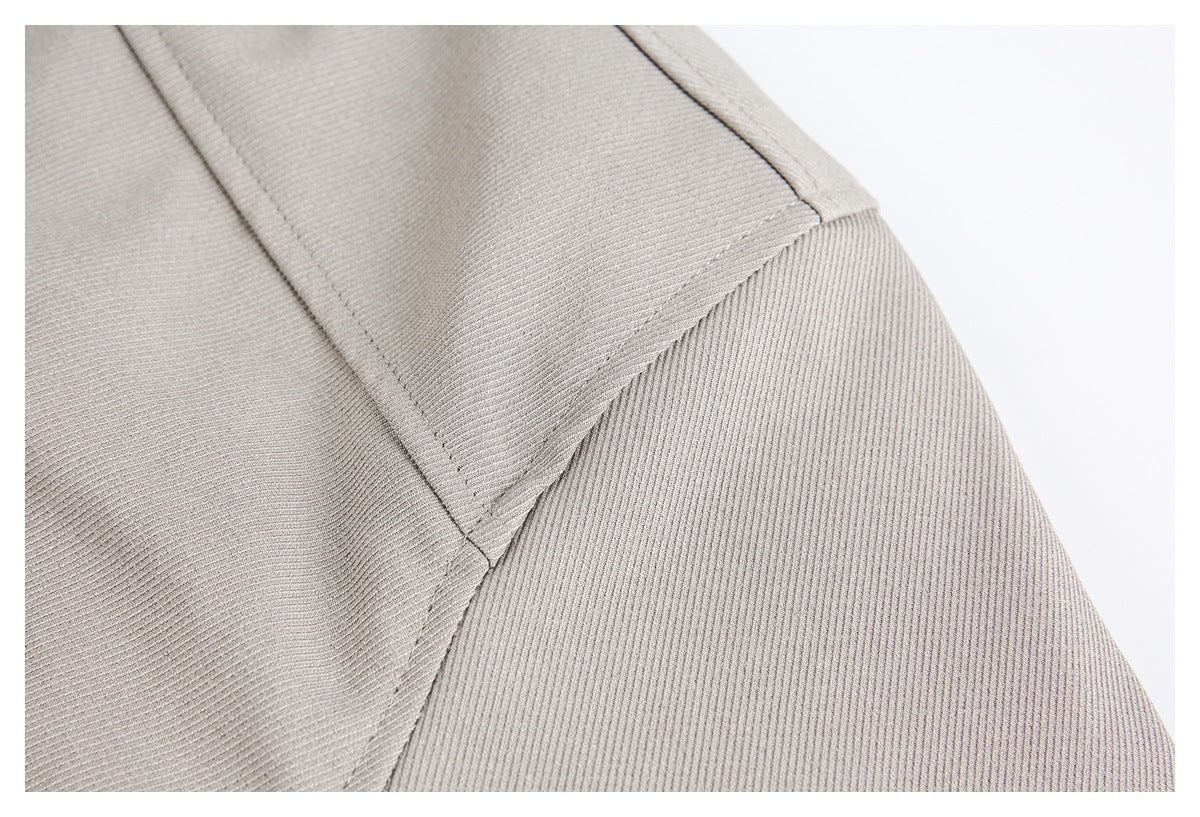 Close-up of stitched panel seams on light taupe fabric.