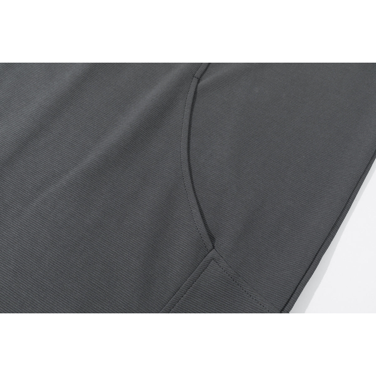 Close-up of charcoal gray sweatshirt fabric and curved stitched panel seams.