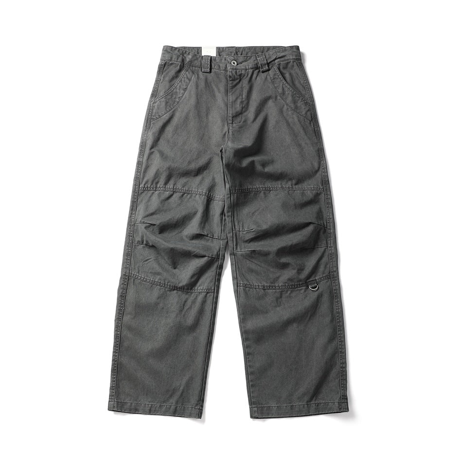 Front view of black-gray wide-leg work pants with knee panel seams, slanted pockets and a small D-ring