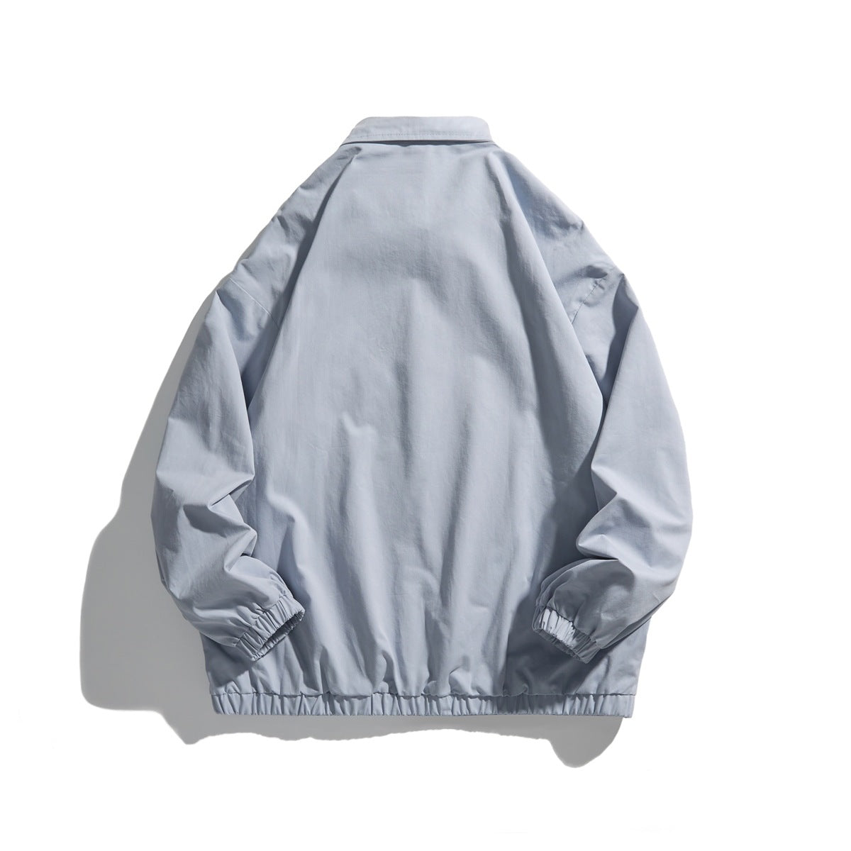 Back view of a light blue-gray collared jacket with long sleeves and elastic cuffs and hem.