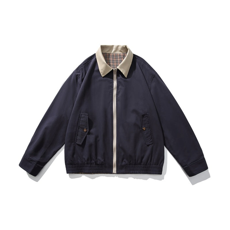 Navy zip-front jacket with khaki collar, light zipper, plaid collar underside, flap pockets and elastic hem, flat lay