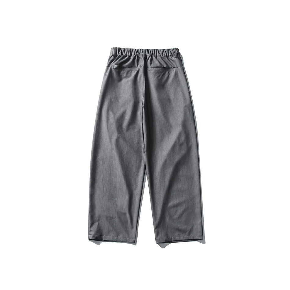 Back view of gray wide-leg trousers with an elastic waistband and two rear pockets.