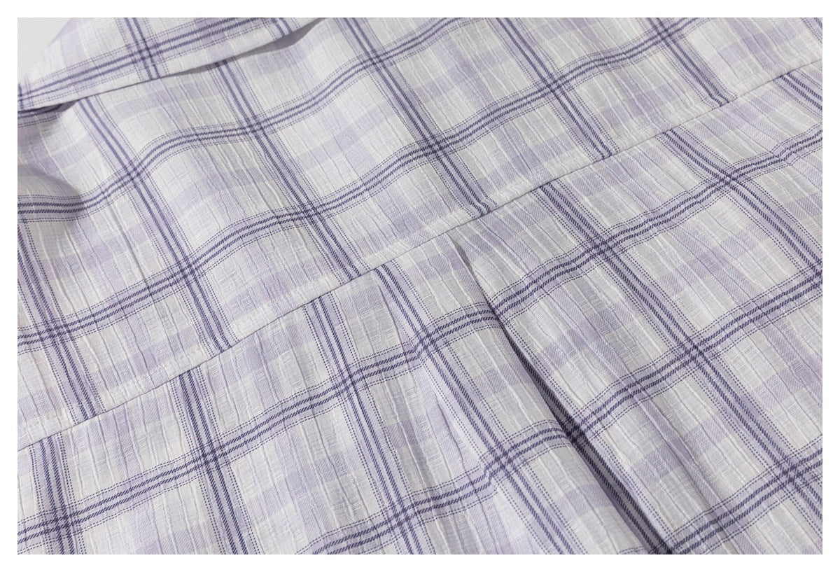 Close-up of the light gray-lavender plaid shirt's back yoke seam and fabric folds.