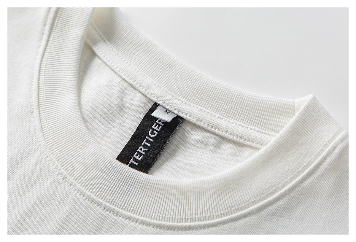 Close-up of a white T-shirt's ribbed crew neckline with a black woven label and size M tag.