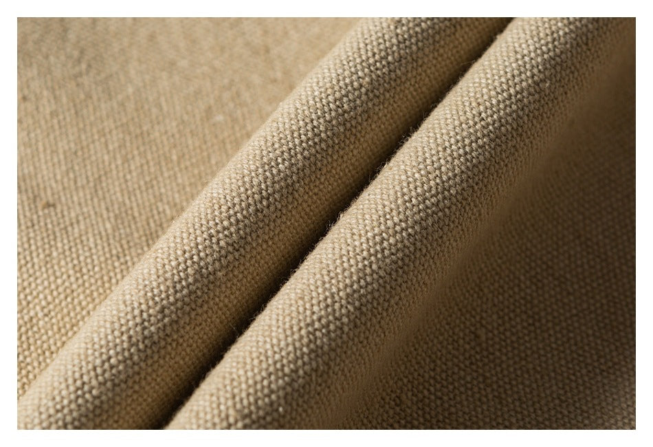 Macro view of the beige jacket's textured fabric folded into soft ridges.