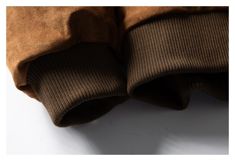 Close-up of a brown jacket's dark ribbed hem.