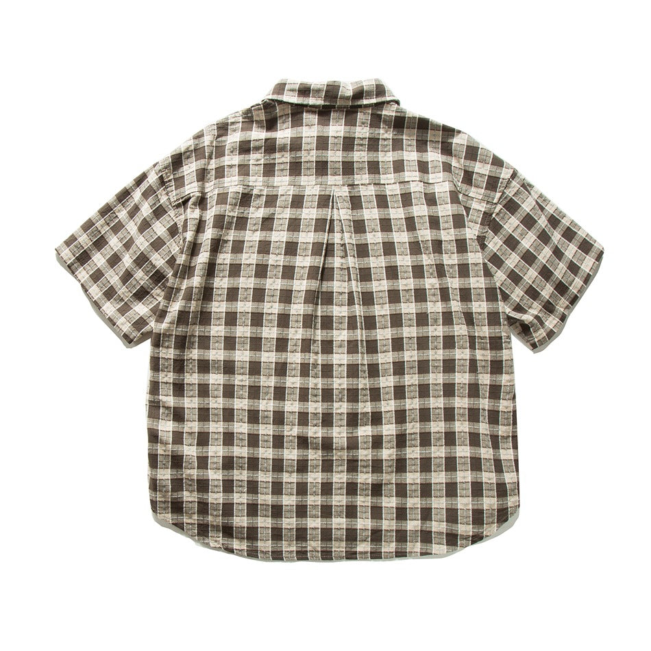Back view of brown and cream plaid short-sleeve shirt with center box pleat at the yoke, flat lay