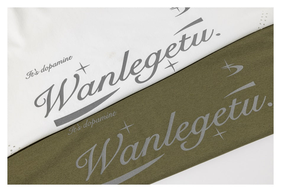White and olive-green shirts shown close up with large gray script graphics and small decorative accents.