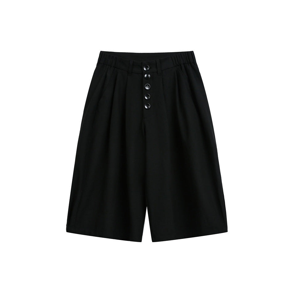 Black knee-length pleated shorts with five front buttons and an elastic waistband, flat front view
