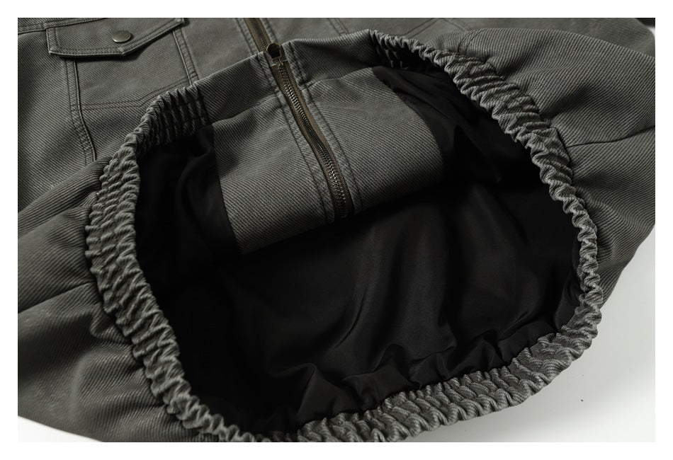 Close-up of the jacket's gathered opening and black lining, with part of the front zipper visible.