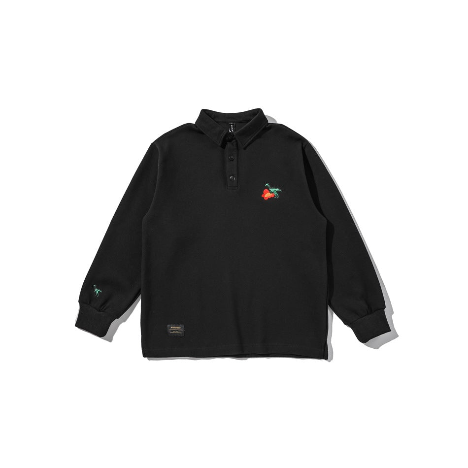 Black long-sleeve polo-collar top flat lay with chest dinosaur embroidery, three buttons and ribbed cuffs