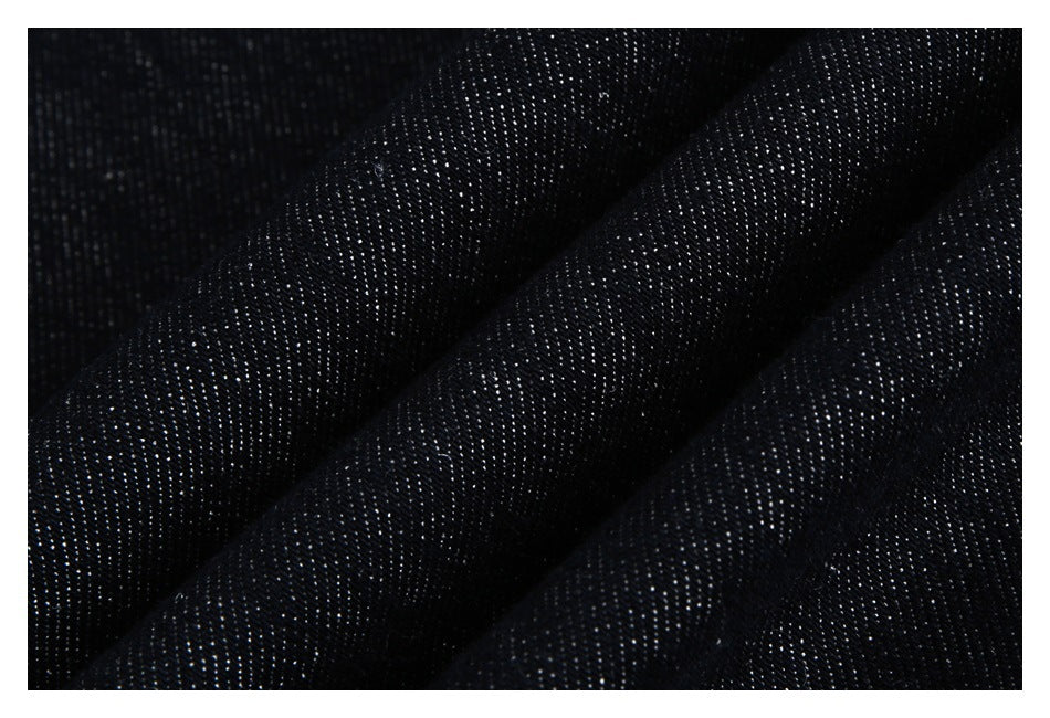 Close-up of dark navy-black fabric with a fine, subtly speckled woven texture.
