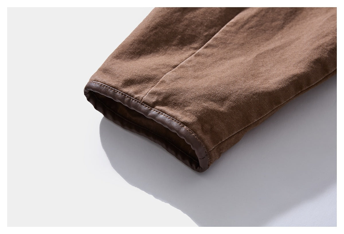 Close-up of a brown jacket sleeve cuff with a stitched edge and darker inner lining.
