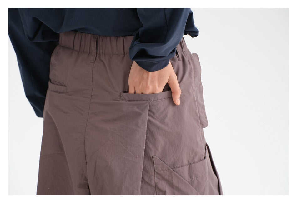 Back view close-up of mauve shorts, showing the elastic waistband and large rear pockets.