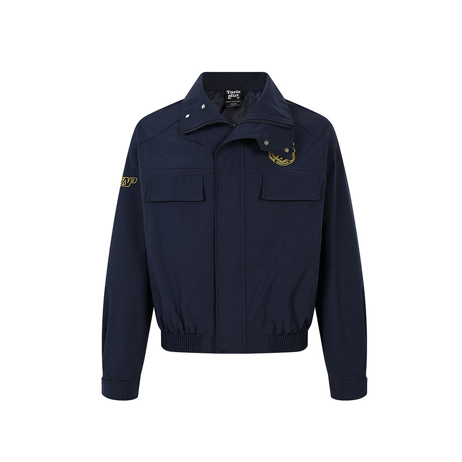 Navy blue zip-front jacket with collar snaps, chest flap pockets, embroidered crest, elastic hem and tabbed cuffs, front view