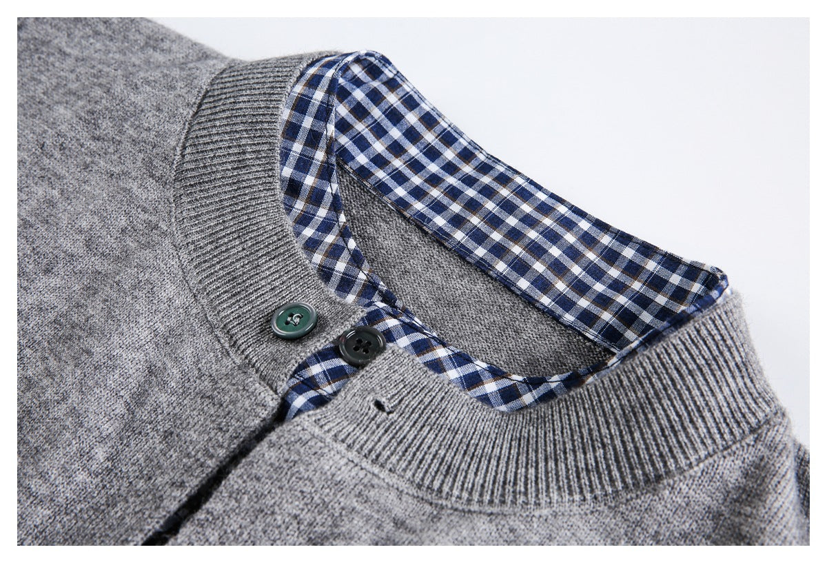 Close-up of a gray sweater neckline showing checked inner trim, ribbed edging, and two buttons.