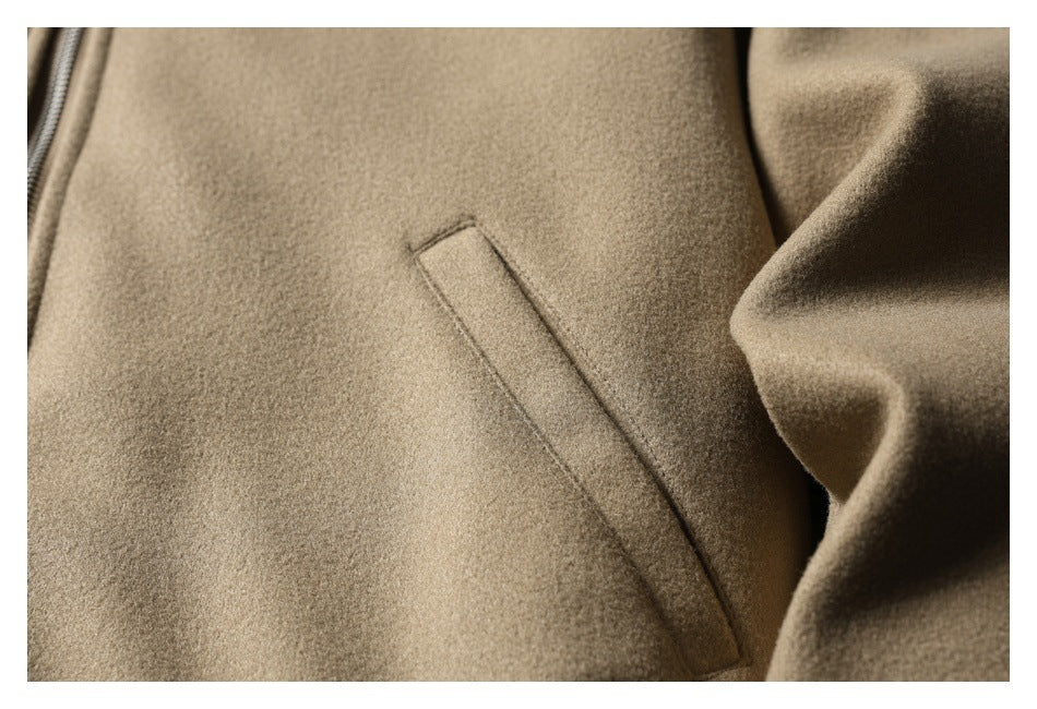 Close-up of a slanted welt pocket on the taupe jacket.