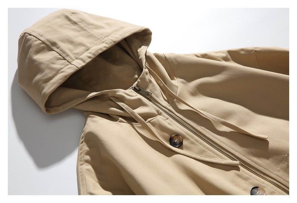 Close-up of the tan jacket's hood, drawstrings, zipper, and buttoned front placket.