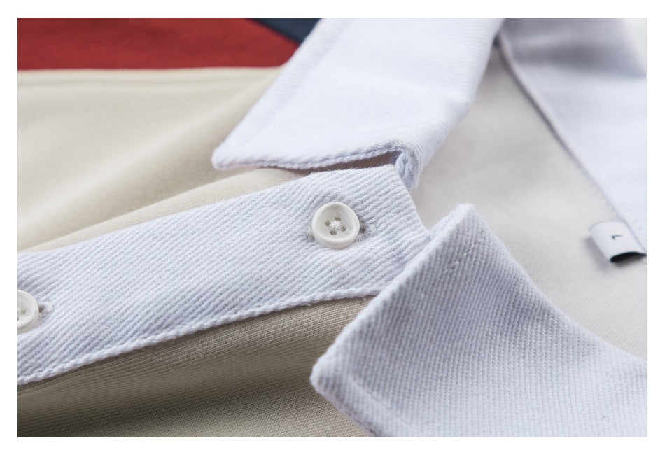 Close-up of a light beige garment placket with white buttons and a white fabric facing.