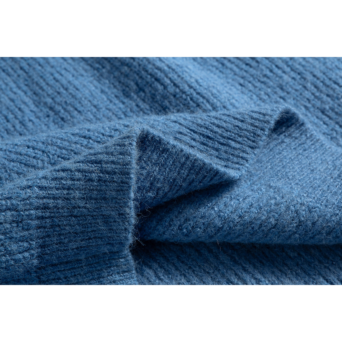Close-up of blue knit fabric and a folded ribbed edge.