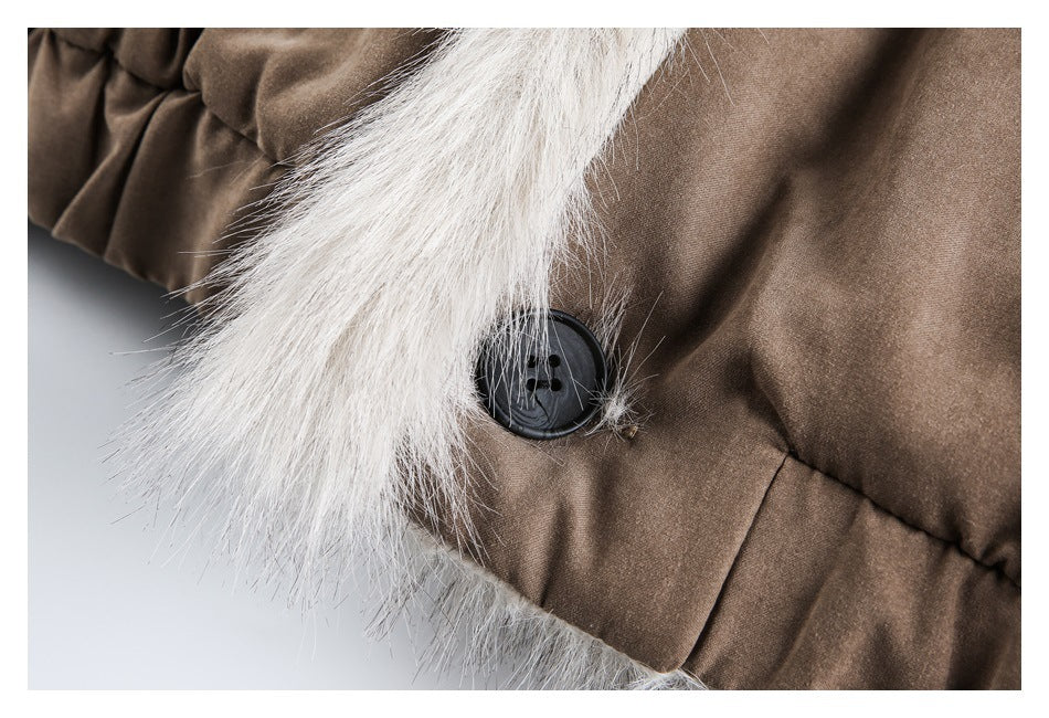 Close-up of a dark button beside pale fluffy trim on a brown jacket.