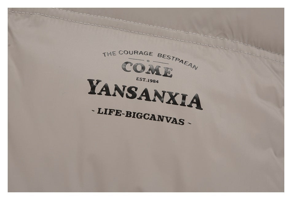 Close-up of black English lettering printed on taupe jacket fabric.