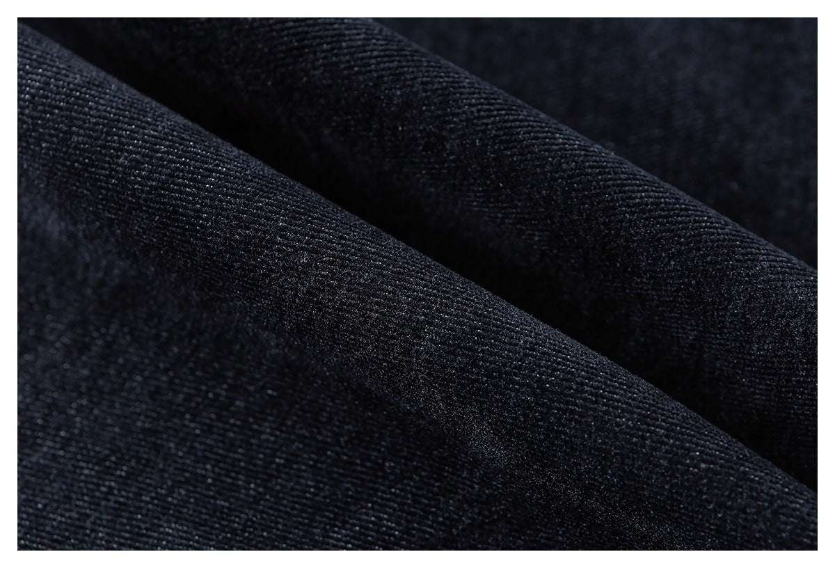 Close-up of dark navy fabric showing its fine woven texture and soft folds.