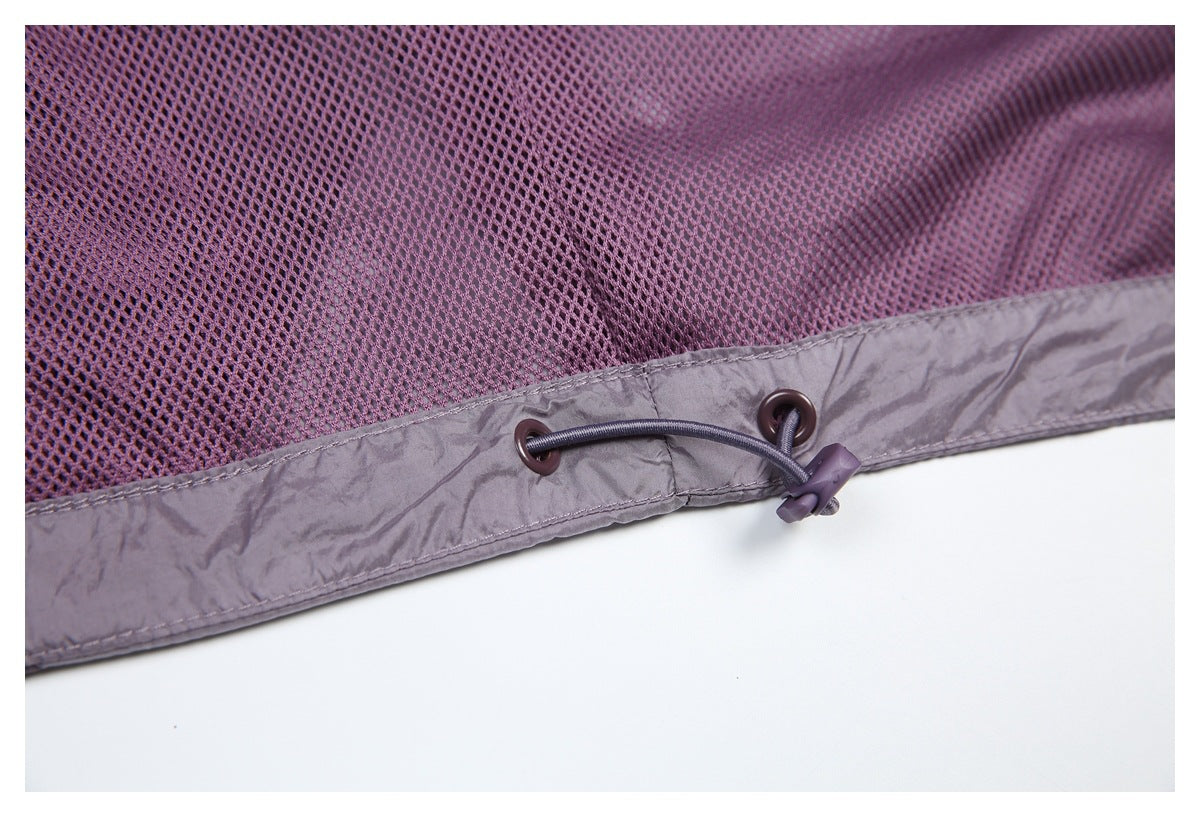 Close-up of purple mesh meeting a gray-mauve hem with metal eyelets and an adjustable drawcord.
