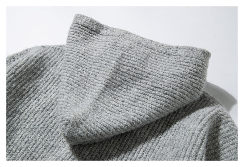 Close-up of the folded ribbed collar of a light gray knit garment.