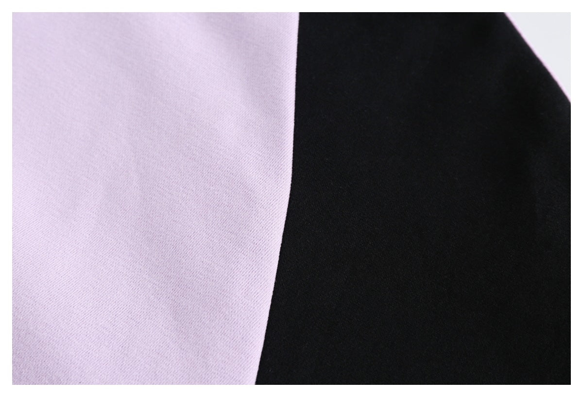 Close-up of lilac and black color-blocked garment fabric.