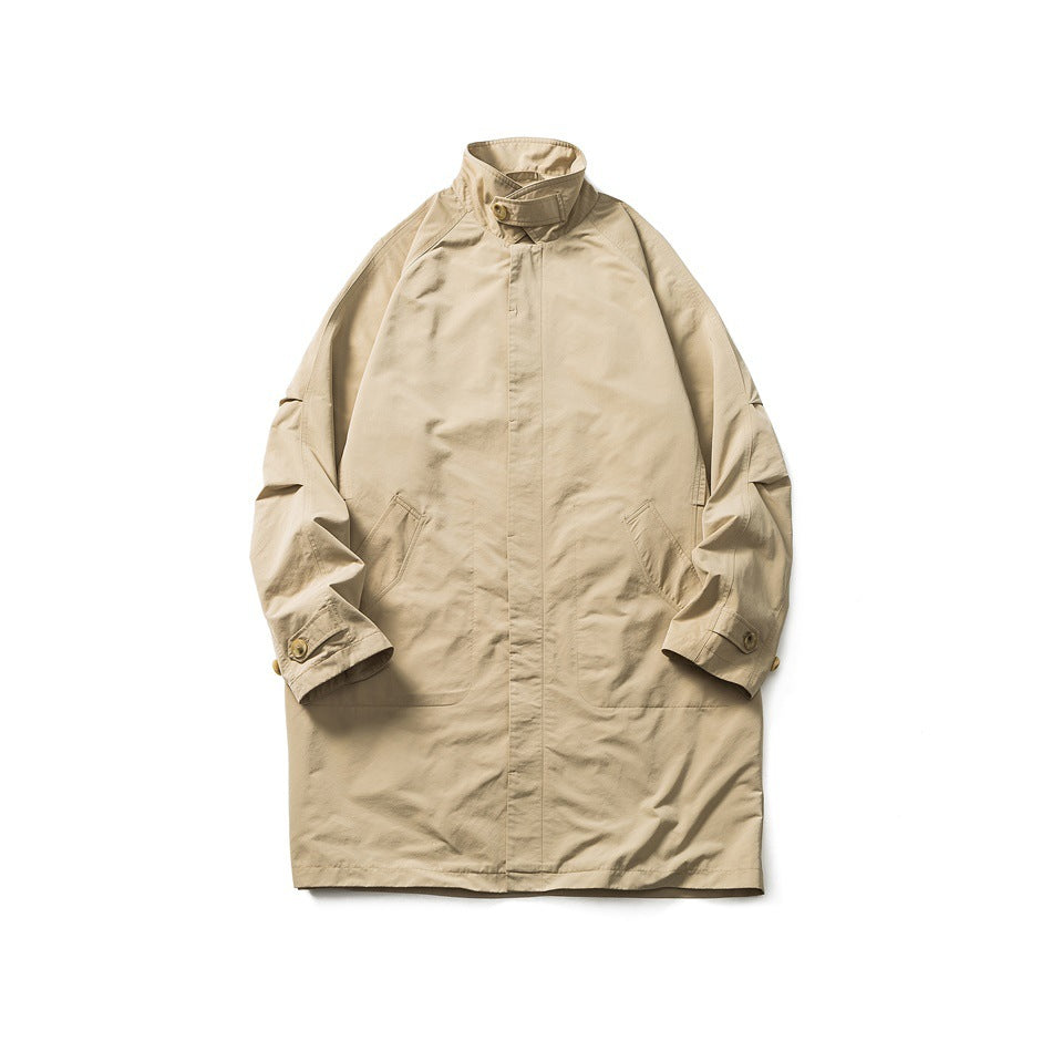 Khaki mid-length stand-collar coat laid flat, front view with concealed placket, pockets and buttoned cuff tabs