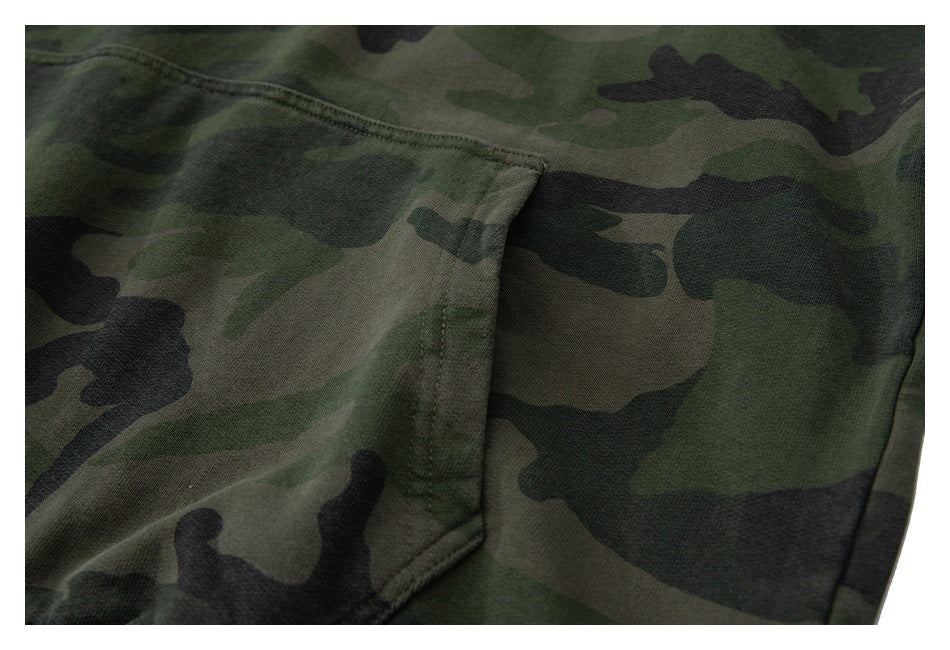Close-up of a camouflage hoodie kangaroo pocket with visible stitching.