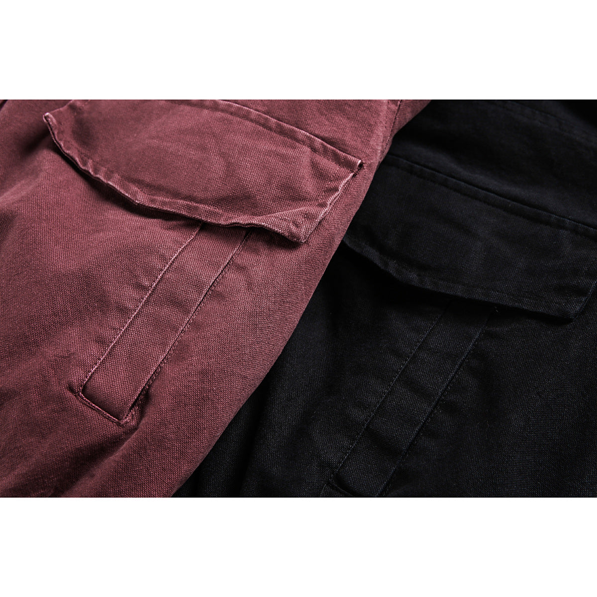 Close-up of burgundy and black jackets showing flap pockets and stitched seams.