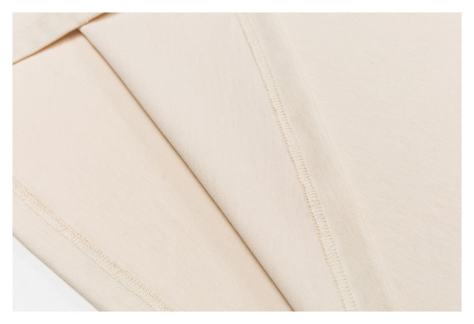 Close-up of the cream shirt's interior seams and overlocked stitching.