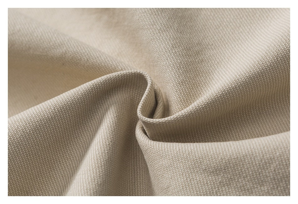 Macro close-up showing the woven texture of beige fabric.