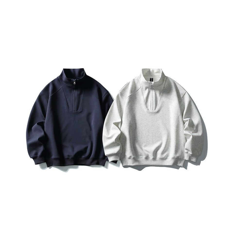 Two quarter-zip sweatshirts shown from the front, one dark navy and one light gray heather.