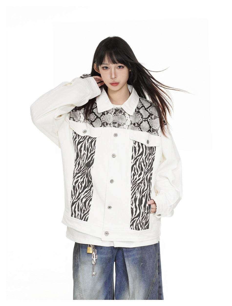 Model wearing a white jacket with snakeskin and zebra-print panels, shown from the waist up.