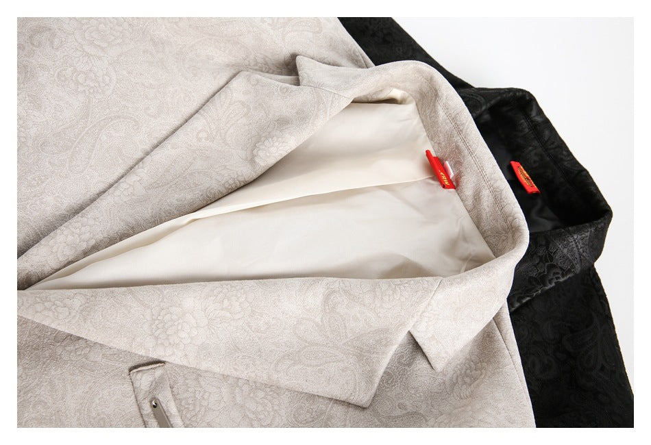 Close-up of light gray and black patterned blazers, showing the pale lining and inner construction of the gray blazer.