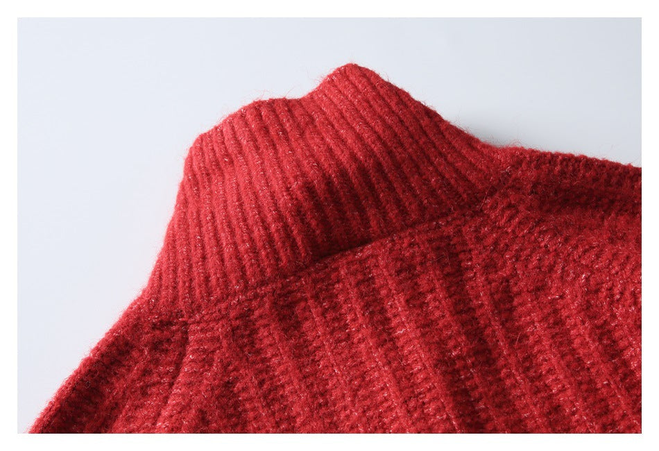 Close-up of a red knit sweater showing its ribbed mock neck and textured body.