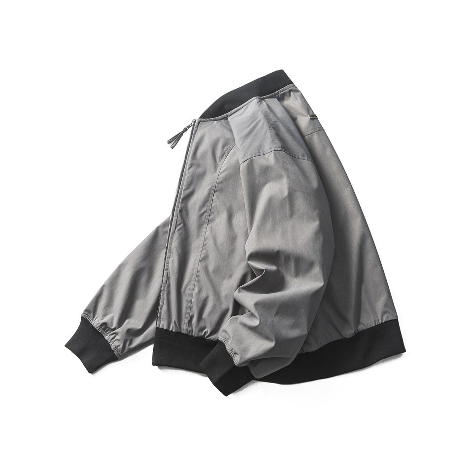 Angled side view of a gray bomber jacket with black ribbed trim and a visible front zipper.