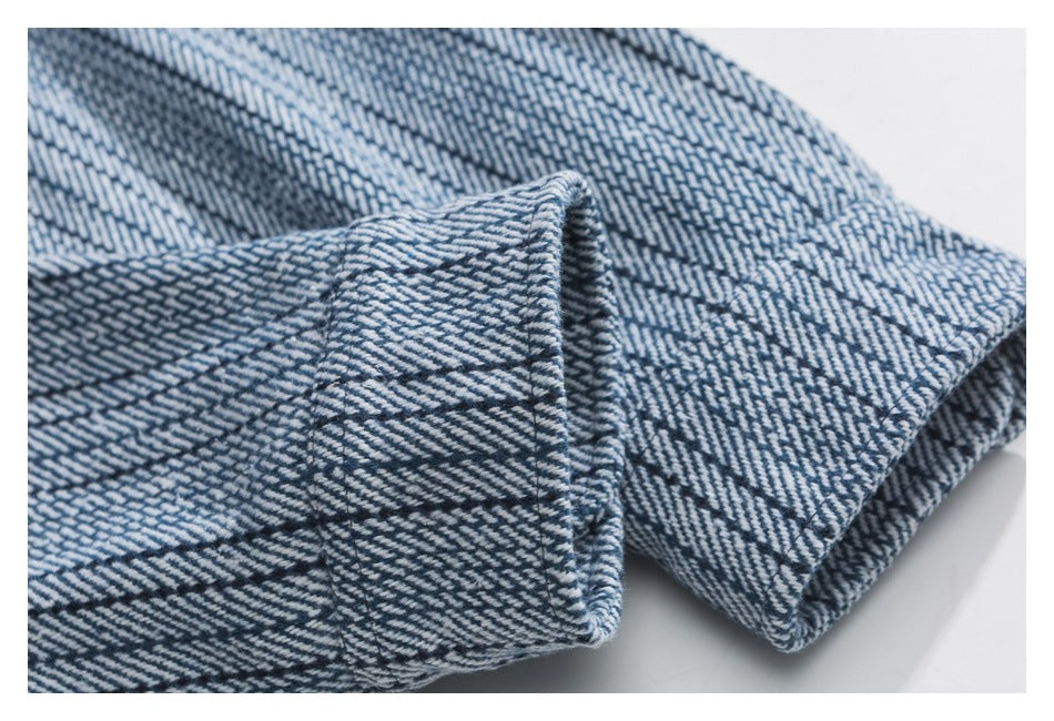 Close-up of the folded cuff of a blue-and-white patterned garment.